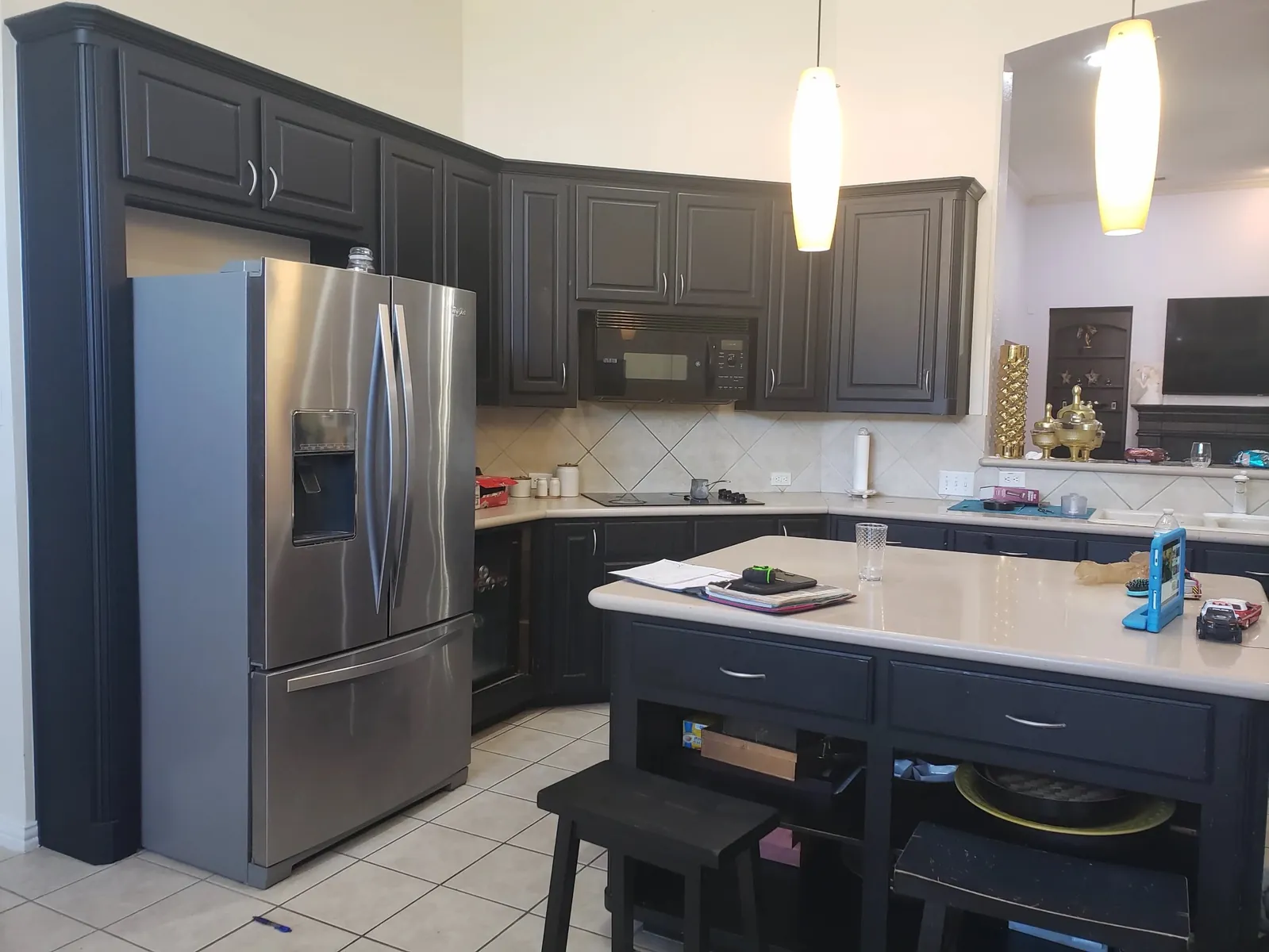 Dated kitchen with dark cabinets before remodeling by Rock Your House Remodeling